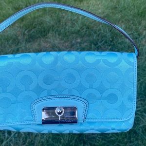 Blue Coach handbag with strap and magnetic closure